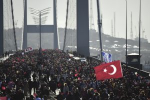People walk on the July 15 Martyrs' Bridge, known as the Bosphorus Bridge, during the 38th annual Istanbul Marathon on November 13, 2016. / AFP PHOTO / YASIN AKGUL