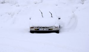 BITLIS, TURKEY - DECEMBER 26: A car covered with snow is seen during heavy winter conditions in Bitlis province of Turkey on December 26, 2016. Roads were closed in at least 210 residential areas due to heavy snow and poor weather conditions. Ibrahim Yaldiz / Anadolu Agency