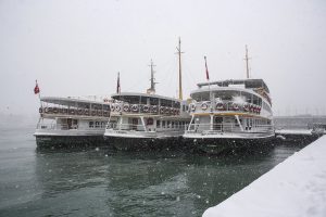 ISTANBUL, TURKEY - JANUARY 07: Docked city line ferries are seen on the Bosphorus during the heavy snowfall in Istanbul, Turkey on January 07, 2017. Arif Hudaverdi Yaman / Anadolu Agency