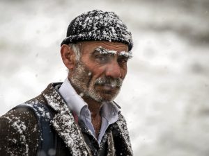 HAKKARI, TURKEY - DECEMBER 01: An old man is seen as heavy snowfall influence living negatively in Hakkari, Turkey on December 01, 2016. There is no transportation to 9 villages and 22 towns due to heavy snowfall. Yilmaz Kazandioglu / Anadolu Agency