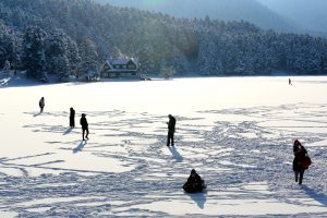BOLU, TURKEY - DECEMBER 19 : People walk on frozen lake at the Golcuk Natural Park in Turkey's Bolu district during winter season on December 19, 2016. Mehmet Emin Gürbüz / Anadolu Agency