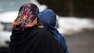 HEMMINGFORD, QUEBEC - FEBRUARY 23: A mother and child from Turkey wait to be put into a police vehicle by the Royal Canadian Mounted Police after they crossed the U.S.-Canada border into Canada, February 23, 2017 in Hemmingford, Quebec. In the past month, hundreds of people have crossed Quebec land border crossings in attempts to seek asylum and claim refugee status in Canada. Drew Angerer/Getty Images/AFP