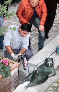 ISTANBUL, TURKEY - NOVEMBER 12 : Kadikoy municipality worker siliconizes the "Tombili" which means cute and chubby statue after stolen and has been found in Istanbul, Turkey on November 12, 2016.Social media phenomenon "Tombili" the Cat had been passed away several months ago. Istanbuls Kadikoy municipality had agreed to erect a statue of her after receiving over 16,000 signatures in an online petition. Metin Tokgoz / Anadolu Agency